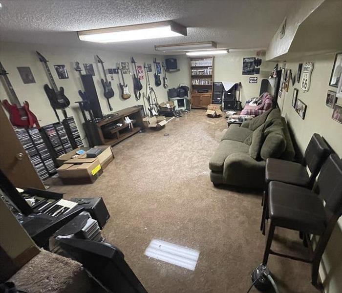 Yukon Oklahoma Basement with standing water and lot of musical instruments in water